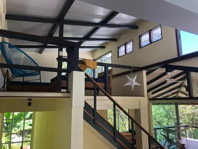 a view of a room with stairs and windows at Jungle Villa copa de árbol, oceanview, infinity in Montezuma