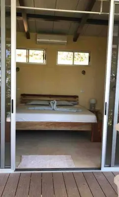 a bedroom with a bed inside of a house at Jungle Villa copa de árbol, oceanview, infinity in Montezuma