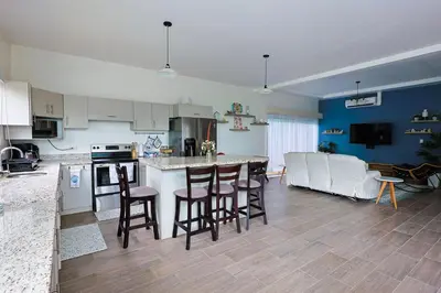 a kitchen and living room with a table and chairs at Casa en puntaleona Condomio Bambu in Quebrada Ganado