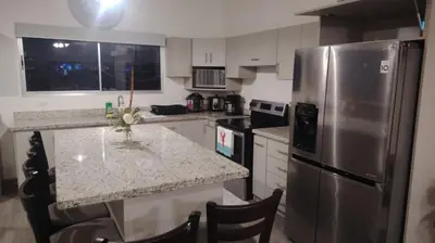 a kitchen with a stainless steel refrigerator and a counter at Casa en puntaleona Condomio Bambu in Quebrada Ganado
