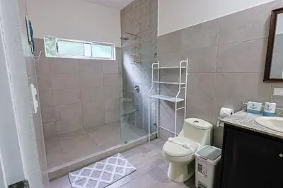 a bathroom with a shower and a toilet and a sink at Casa en puntaleona Condomio Bambu in Quebrada Ganado