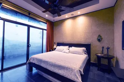 a bedroom with a bed and a large window at Beautiful estate in quiet surroundings close to beach in Naranjito