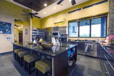 a large kitchen with a large island with bar stools at Beautiful estate in quiet surroundings close to beach in Naranjito