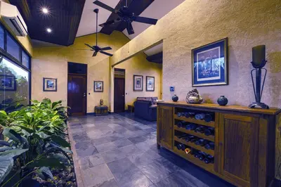 a large room with a wine cabinet with wine bottles at Beautiful estate in quiet surroundings close to beach in Naranjito