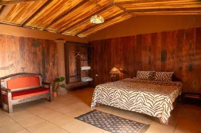 a bedroom with a bed and a chair in it at Terraé Eco-Sanctuary in Santa Elena