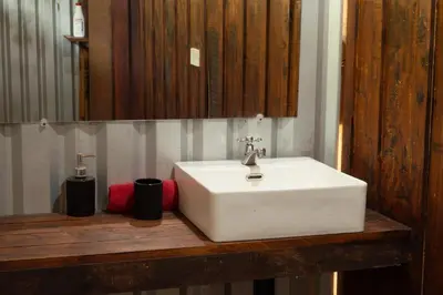 a bathroom with a white sink and a mirror at Terraé Eco-Sanctuary in Santa Elena