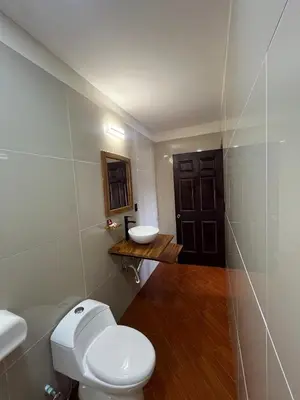 a bathroom with a white toilet and a sink at Hotel Wilson Upala in Upala