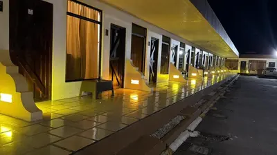 a building with a row of windows on the side of it at Hotel Wilson Upala in Upala