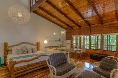 a bedroom with a bed and a table and chairs at Hotel Guiones in Nosara