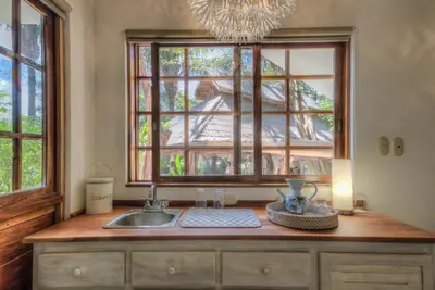 a kitchen counter with a sink and a window at Hotel Guiones in Nosara