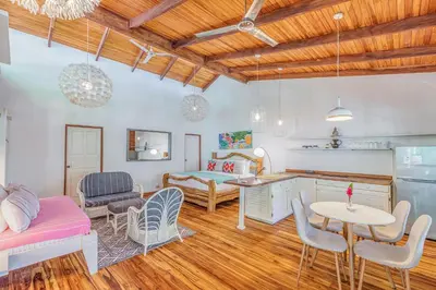 a kitchen and living room with a table and chairs at Hotel Guiones in Nosara