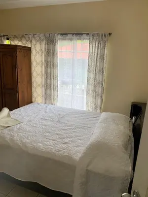 a bedroom with a white bed and a window at Beach house Matapalo Santa Cruz in Matapalo