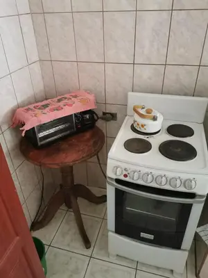a kitchen with a stove and a table with a toaster at Beach house Matapalo Santa Cruz in Matapalo