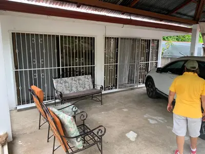 a man standing on a screened in porch with a car at Beach house Matapalo Santa Cruz in Matapalo