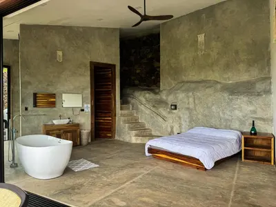 a bedroom with a bed and a bath tub at Destino Hotel & Hot Springs - Lujoso hotel en Provincia Guanacaste, San Bernando de Bagaces, Bagaces in Bagaces
