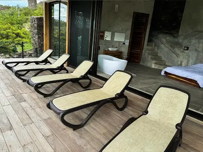 four chairs and a bed in a room with a bathroom at Destino Hotel & Hot Springs - Lujoso hotel en Provincia Guanacaste, San Bernando de Bagaces, Bagaces in Bagaces