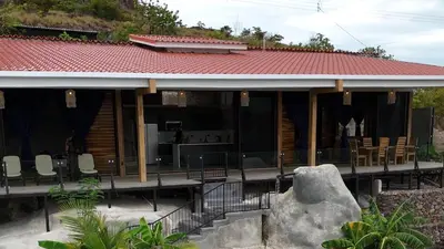 a house with a large rock in front of it at Destino Hotel & Hot Springs - Lujoso hotel en Provincia Guanacaste, San Bernando de Bagaces, Bagaces in Bagaces