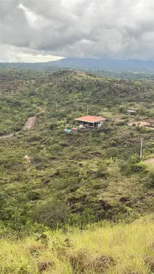 a house in the middle of a field of grass at Destino Hotel & Hot Springs - Lujoso hotel en Provincia Guanacaste, San Bernando de Bagaces, Bagaces in Bagaces