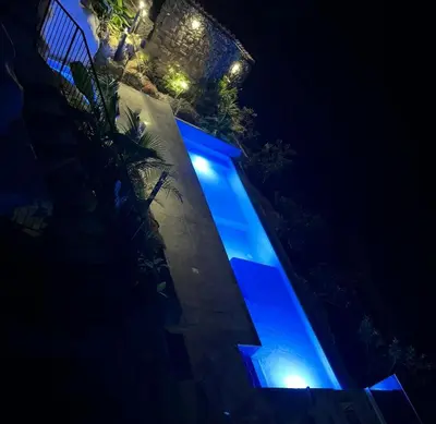 a building with blue lights on it at night at Destino Hotel & Hot Springs - Lujoso hotel en Provincia Guanacaste, San Bernando de Bagaces, Bagaces in Bagaces