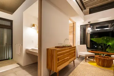 a bathroom with a wooden dresser and a sink at The Gilded Iguana in Nosara