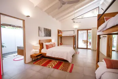 a bedroom with a bed and a large window at The Gilded Iguana in Nosara