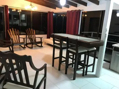 a dining room with a table and chairs in a room at Casa Panorámica con Jacuzzi balcon. Familia Amigos in Robles