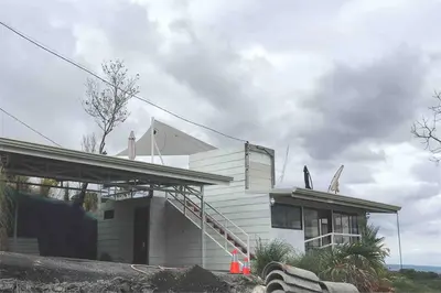 a white house with a staircase next to a building at Casa Panorámica con Jacuzzi balcon. Familia Amigos in Robles