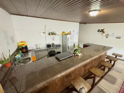 a kitchen with a counter with a laptop on it at Passifloras Hostel in Quepos
