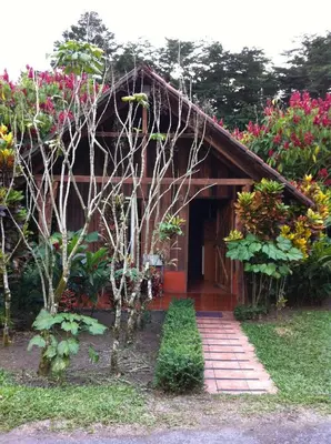 a house with a pathway in front of it at Hotel Villas Vista Arenal in Fortuna