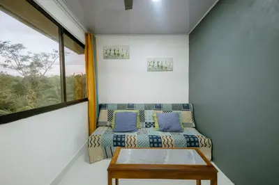 a room with a couch and a table and a window at Vista del Pacifico Boutique Hotel in Quepos