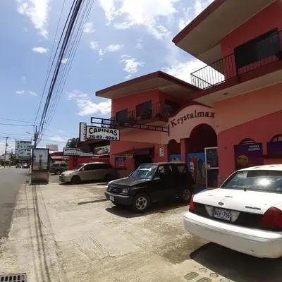 a group of cars parked in front of a building at ECONOMIQUE in Jacó