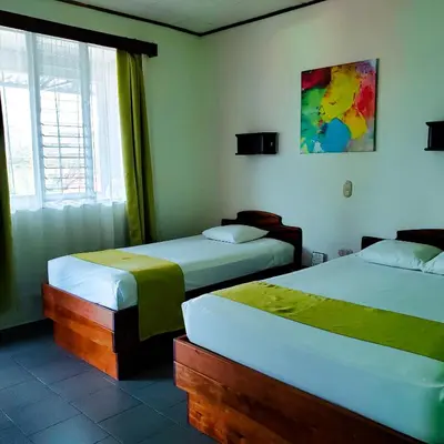 a bedroom with two beds and a window at San Bosco Inn in Fortuna