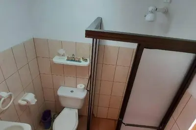 a small bathroom with a toilet and a sink at Beach House with a Pool-2mn walk to the beach in Playa Guacalillo
