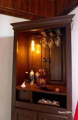 a wooden cabinet with glasses on top of it at Beach House with a Pool-2mn walk to the beach in Playa Guacalillo
