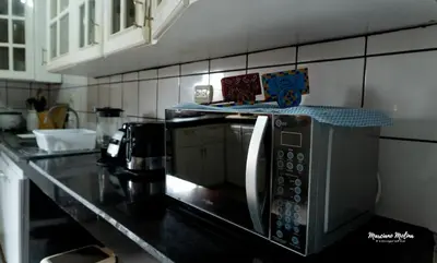 a microwave in a kitchen with a counter top at Beach House with a Pool-2mn walk to the beach in Playa Guacalillo