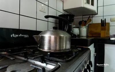 a tea kettle on top of a stove in a kitchen at Beach House with a Pool-2mn walk to the beach in Playa Guacalillo