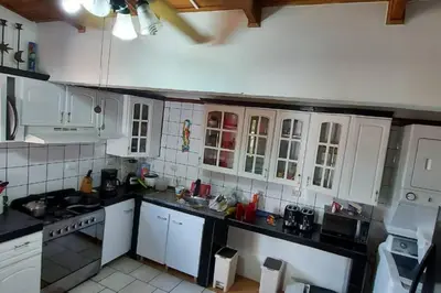 a kitchen with white cabinets and white appliances at Beach House with a Pool-2mn walk to the beach in Playa Guacalillo