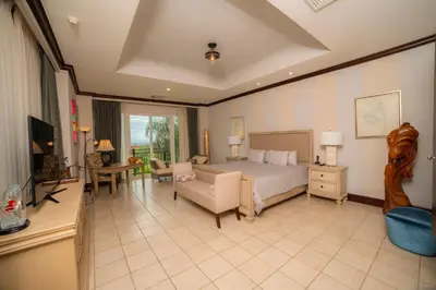 a large bedroom with a bed and a living room at Vista Bahia 3C 3 bdr Ocean View in Los Suenos in Herradura