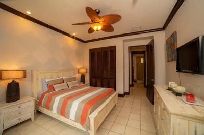 a bedroom with a bed and a flat screen tv at Vista Bahia 3C 3 bdr Ocean View in Los Suenos in Herradura