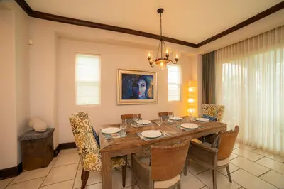a dining room with a wooden table and chairs at Vista Bahia 3C 3 bdr Ocean View in Los Suenos in Herradura