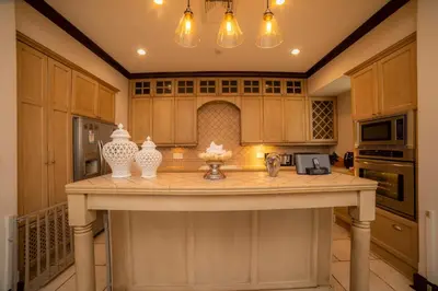a kitchen with a large island with vases on it at Vista Bahia 3C 3 bdr Ocean View in Los Suenos in Herradura