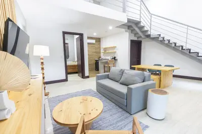 a living room with a couch and a table at Paradise Bay Hotel Boutique in Herradura