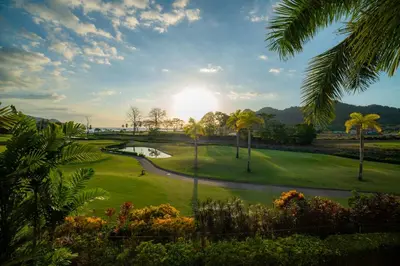 a view of a golf course with palm trees at Del Mar 1G 3 bdr Ocean View in Los Suenos in Herradura