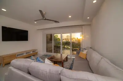 a living room with a couch and a tv at Del Mar 1G 3 bdr Ocean View in Los Suenos in Herradura