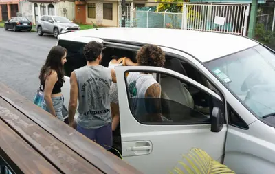 a group of people getting into a white van at Argdivan Hostel in Fortuna