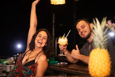 a man and a woman holding up a drink at Argdivan Hostel in Fortuna