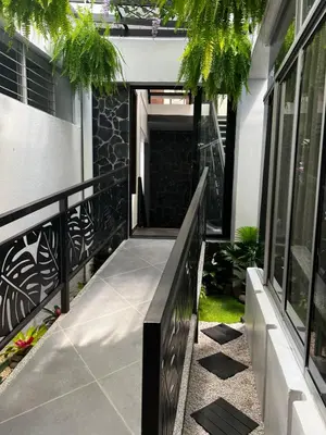 a balcony of a house with a railing and plants at Hotel Arenal by Regina in Fortuna