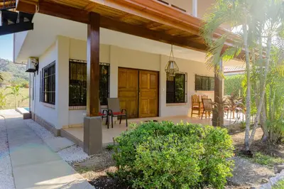 a house with a porch with a patio at Hotel Casa Buenavista - Adults only in Sámara