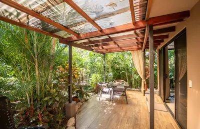 a wooden deck with a pergola in a house at Hotel Casa Buenavista - Adults only in Sámara