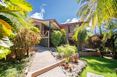 a house with a garden in front of it at Hotel Casa Buenavista - Adults only in Sámara
